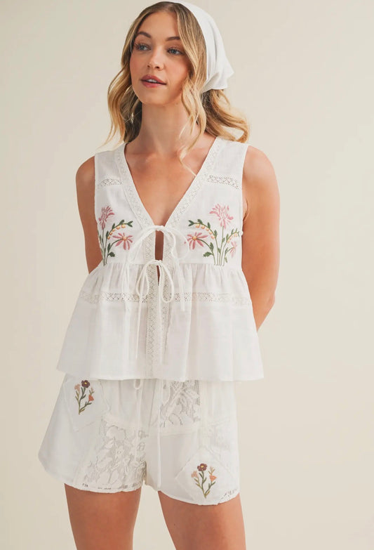 Women’s embroidered tie front babydoll top with floral details