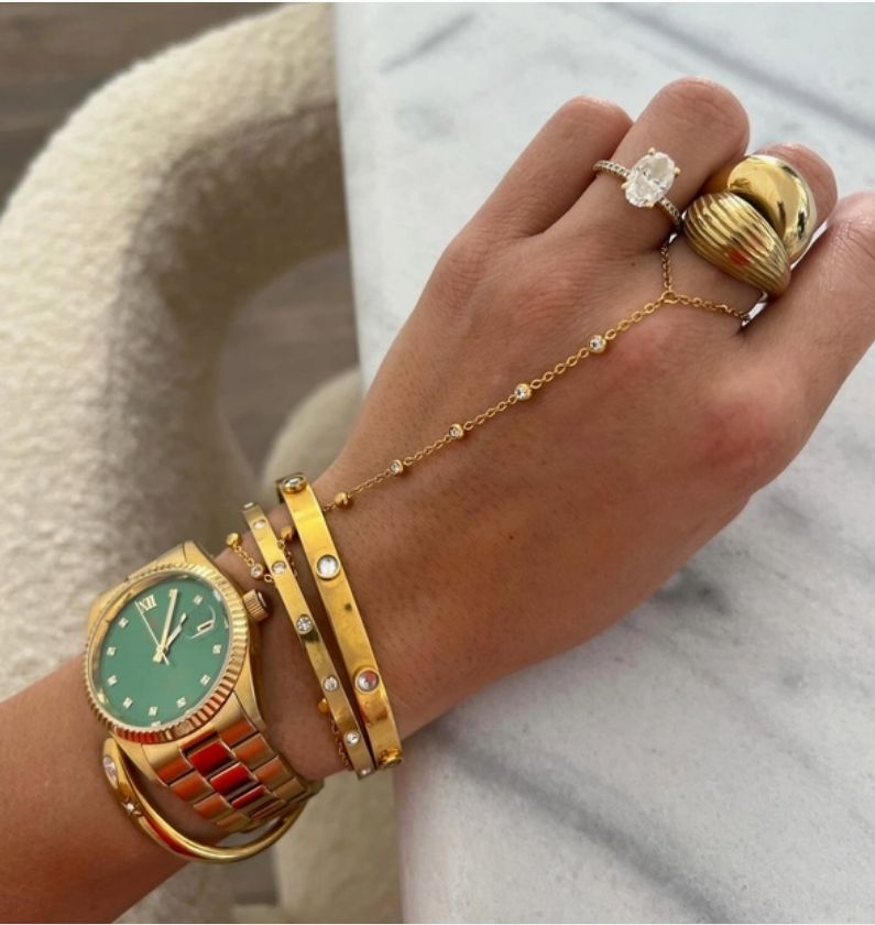 Model wearing gold hand chain
