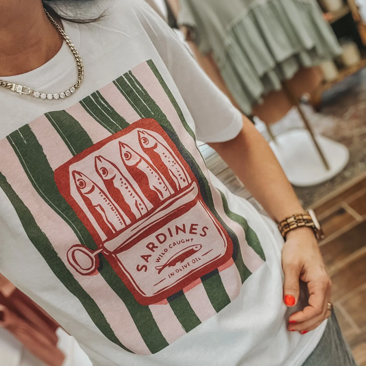Model wearing sardine graphic tee