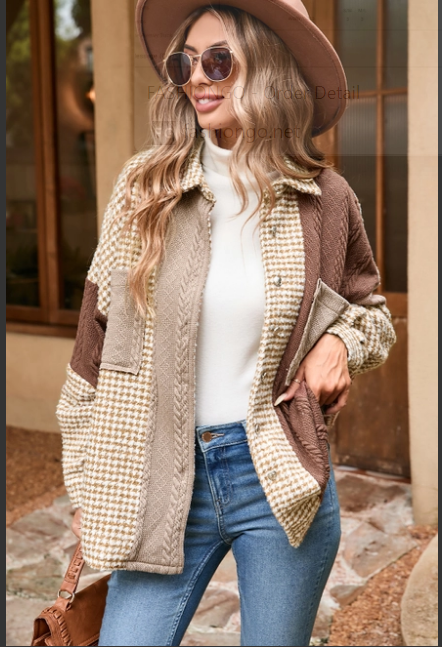 Model wearing beige and brown shacket with hat and sunglasses